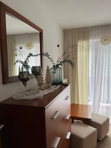a bathroom with a dresser with a mirror and a chair at Chata Janet in Martin