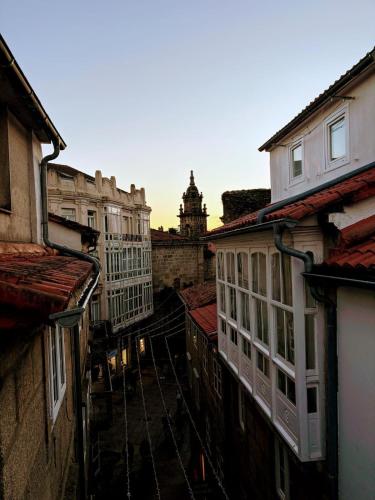 a view of an alley with buildings and a clock tower at Hotel Real in Santiago de Compostela