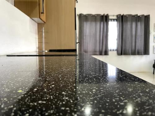 a black floor in a room with curtains at Spring Valley Vista, Ocean View Apartment Ocho Rios in Tower Isle