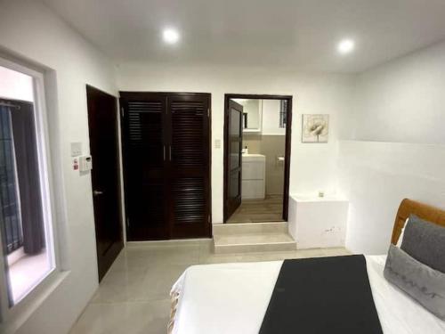a bedroom with a bed and a large mirror at Spring Valley Vista, Ocean View Apartment Ocho Rios in Tower Isle