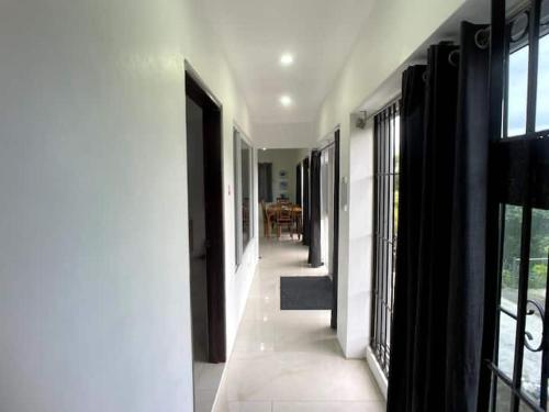 a hallway of a house with a view of a dining room at Spring Valley Vista, Ocean View Apartment Ocho Rios in Tower Isle