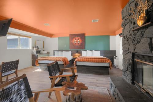 a bedroom with two beds and a fireplace at Sessions Retreat & Hotel in Big Bear Lake
