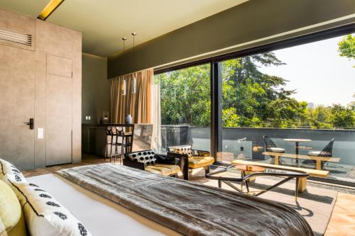 a bedroom with a large bed and a large window at El Alfonsa in Mexico City