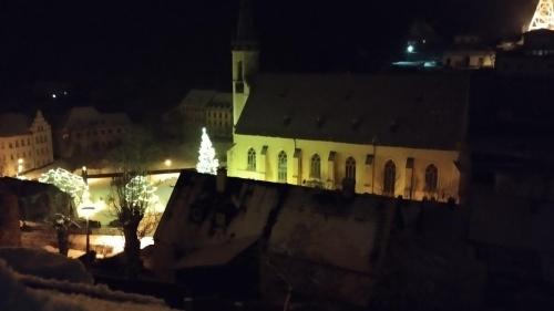a building with a christmas tree on top of it at night at Apartman Albreit 3 in Jáchymov