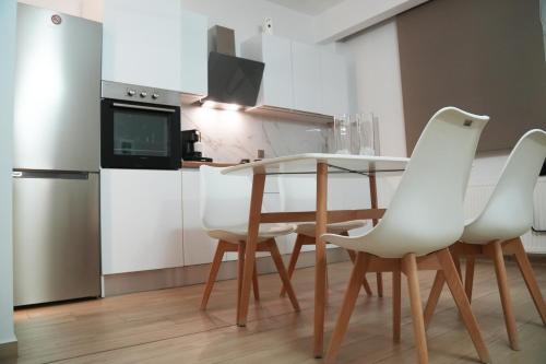 a kitchen with a table and chairs and a refrigerator at Riverside in Florina