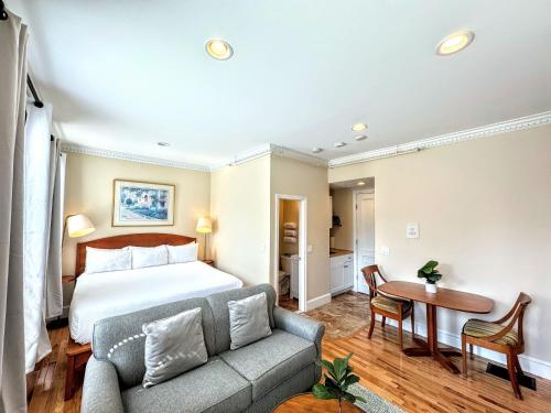 a hotel room with a bed and a couch at Copley House in Boston