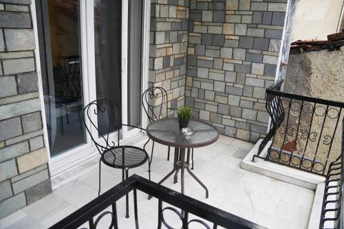 a patio with two chairs and a table on a balcony at Riverside in Florina