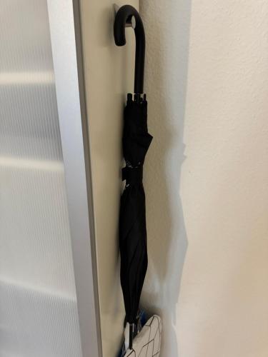 a black umbrella is hanging on a wall at City Center Rooftop Studio with Oldtown View in Basel