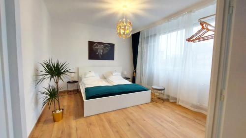 a small bedroom with a bed and a window at Central Station Lux Downtown Apartman in Budapest
