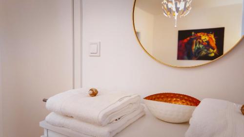 a pile of towels on a table with a mirror at Central Station Lux Downtown Apartman in Budapest