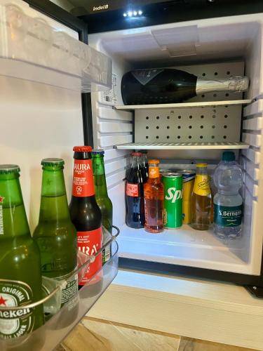 an open refrigerator filled with lots of bottles of beer at Angelina's Suite&Spa con parcheggio privato in Como