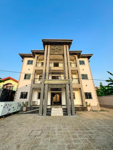 a large building with the front of it at Novel Apartments in Limbe