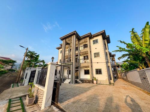 an old building with a gate in front of it at Novel Apartments in Limbe
