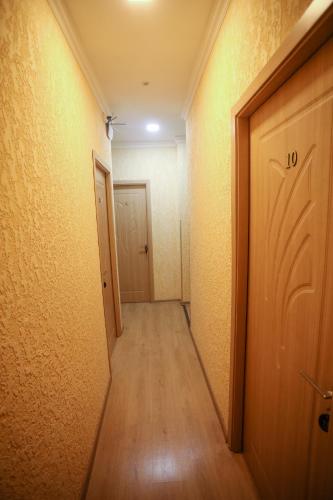 an empty hallway with a door and wooden floor at hWB in Kutaisi