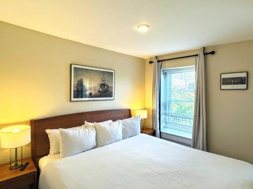 a bedroom with a white bed and a window at Copley House in Boston