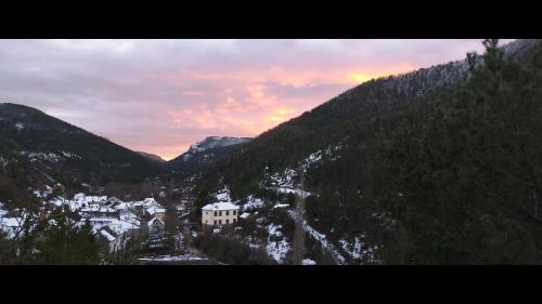 a view of a mountain with a house in the snow at Casa Tadeguaz in Fago