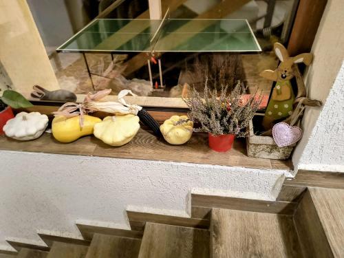 a table with some plants and a table with a window at Poiana Sașilor - Valea Doftanei in Trăisteni