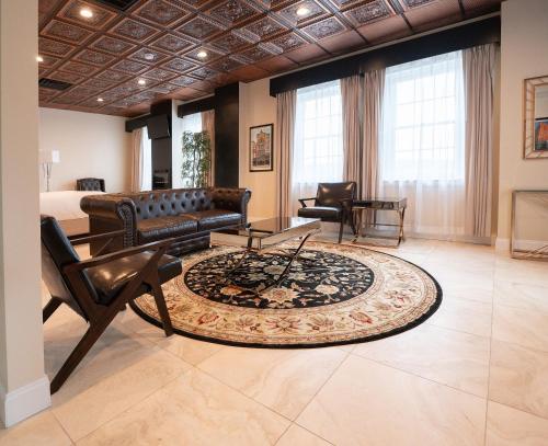 a living room with a couch and a rug at The Americus Hotel, Trademark Collection by Wyndham in Allentown