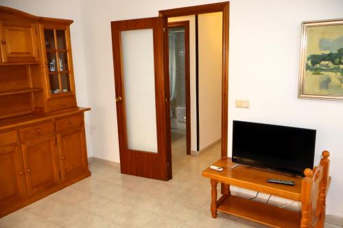 a living room with a flat screen tv on a table at Los Pescadores playa LEK in Peñíscola