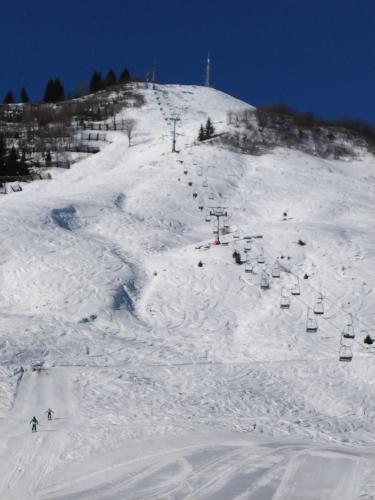 a snow covered ski slope with a ski lift at Faschina Apartment - Top 4 in Fontanella