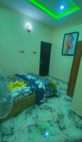 a bedroom with a bed on a marble floor at Your Elegant Home in Lagos