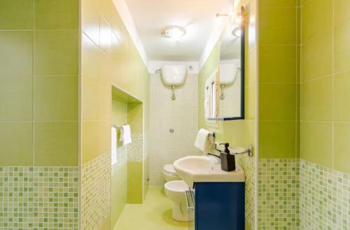 a bathroom with a sink and a toilet at Dimora Borbonica in Ercolano