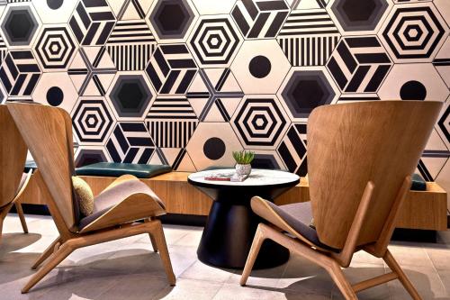 a room with chairs and a table and a wall at The Clancy, Autograph Collection in San Francisco