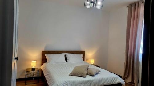 a bedroom with a bed with two pillows on it at Denisa in Limanu
