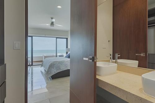 a bathroom with a bed and a tub and a sink at Zirene, Depto con jacuzzi priv in Chicxulub