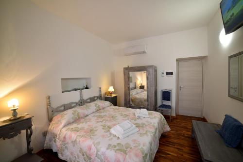 a bedroom with a bed and a large mirror at Il Palazzetto in Bolsena