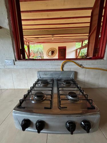 a stove top oven in a kitchen with a window at Finca La Macarena by Welttisch in Génova