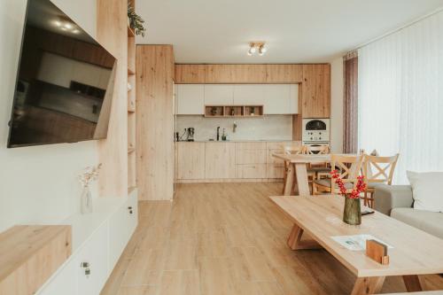 a living room with a table and a kitchen at Apartment Aria 2 in Velingrad
