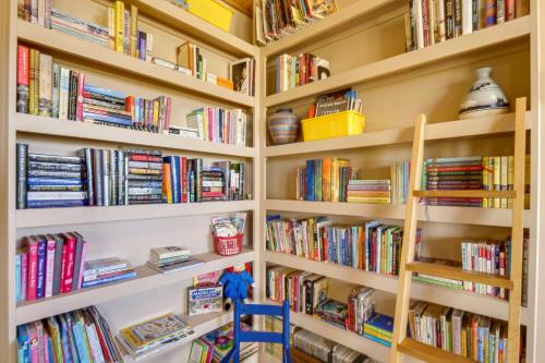 a library filled with lots of books at 24-0089 Rustic Hartsel Getaway with 35-Acre Yard in Fairplay