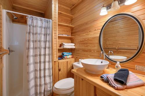 a bathroom with a sink and a mirror at Bison Hollow Hideaway in South Bloomingville