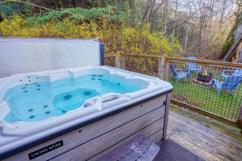 a large hot tub sitting on a deck at Bison Hollow Hideaway in South Bloomingville