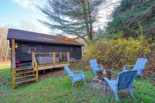a group of blue chairs in front of a cabin at Bison Hollow Hideaway in South Bloomingville
