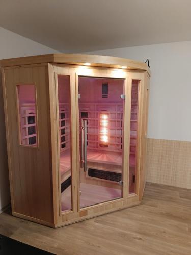 a wooden cabinet with a glass door in a room at Chalupa u Martina in Vápenice