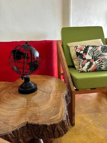 a globe on a table next to a chair at Finca La Macarena by Welttisch in Génova