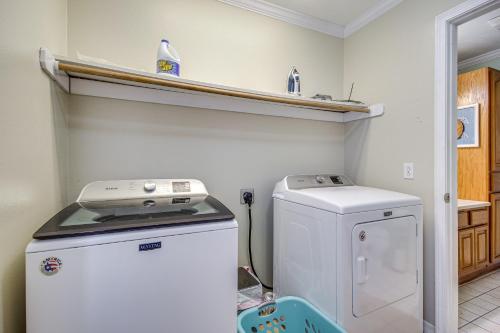 a small kitchen with a white refrigerator and a stove at Less Than 1 Mi to Waveland Beach Spacious Family Home in Waveland