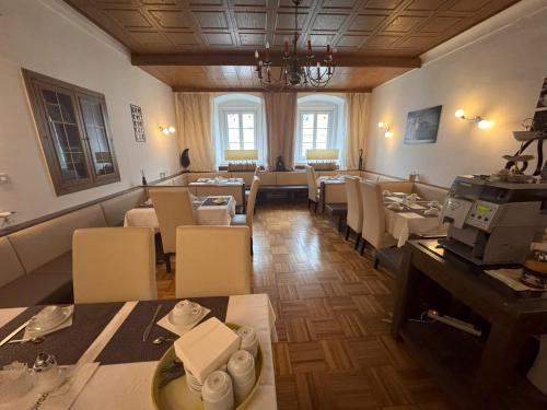 a dining room with tables and chairs and windows at Austria Traveller Hotel Kirchdorf in Kirchdorf an der Krems