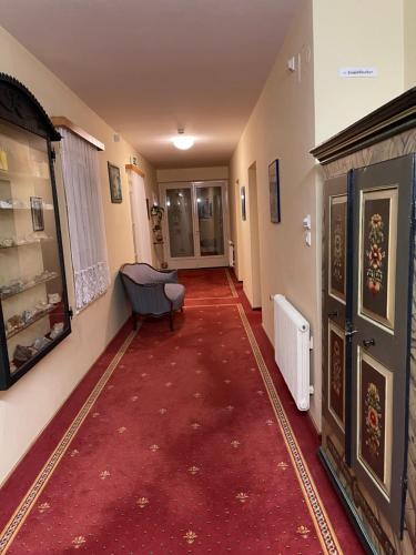 a hallway with a red carpet in a house at Brunnhof Gastein in Bad Hofgastein