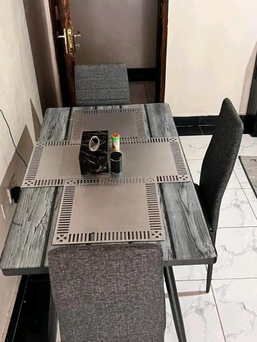 a wooden table with a camera on top of it at Affordable Studio - WIFI, Netflix & Parking in Kikuyu