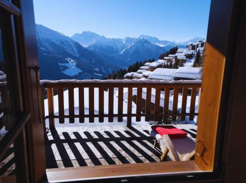 a balcony with a view of a snow covered mountain at Chratidudel - Ski-in , Ski-out in Bettmeralp