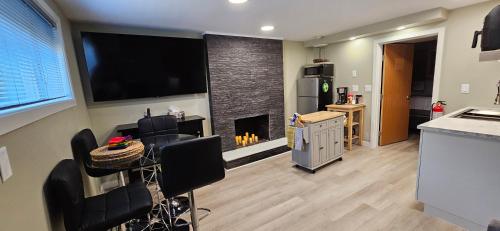 a kitchen with a living room with a fireplace at 1 block to Kelowna General Hospital 2 blocks to Beach 1km to OUC 1km to Downtown Kelowna 20min to YLW in Kelowna