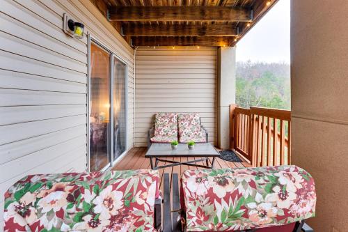 a porch with two chairs and a table on it at 1 Mi to Silver Dollar City! Lake-View Family Haven in Branson