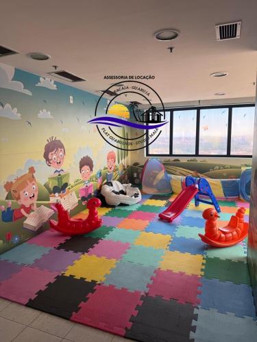 a childrens play room with a mural on the wall at Flat Hotel em Guarulhos in Guarulhos