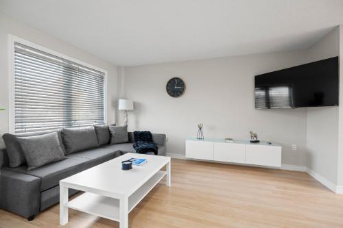 a living room with a couch and a table at Happy Life in Barrie