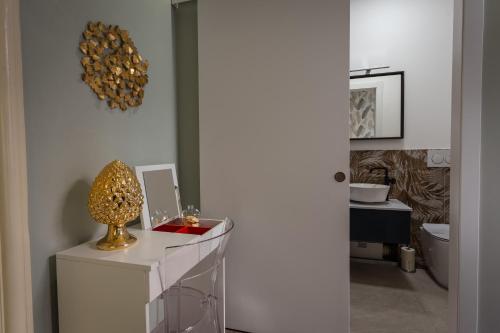 a bathroom with a counter with a trophy on it at Etnea Boutique Hotel in Catania