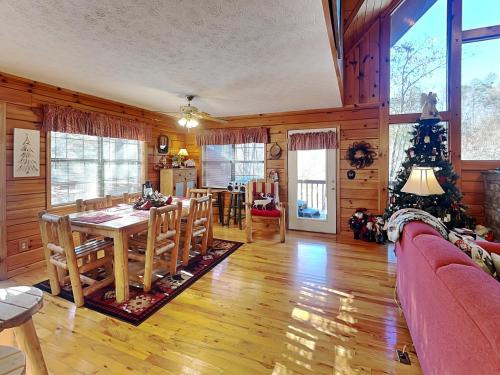 a dining room and living room with a table and chairs at Mountain Mist in Sevierville