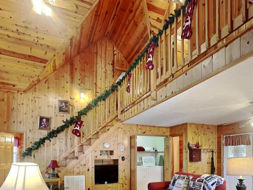 a room with wooden walls and stairs with christmas decorations at Mountain Mist in Sevierville